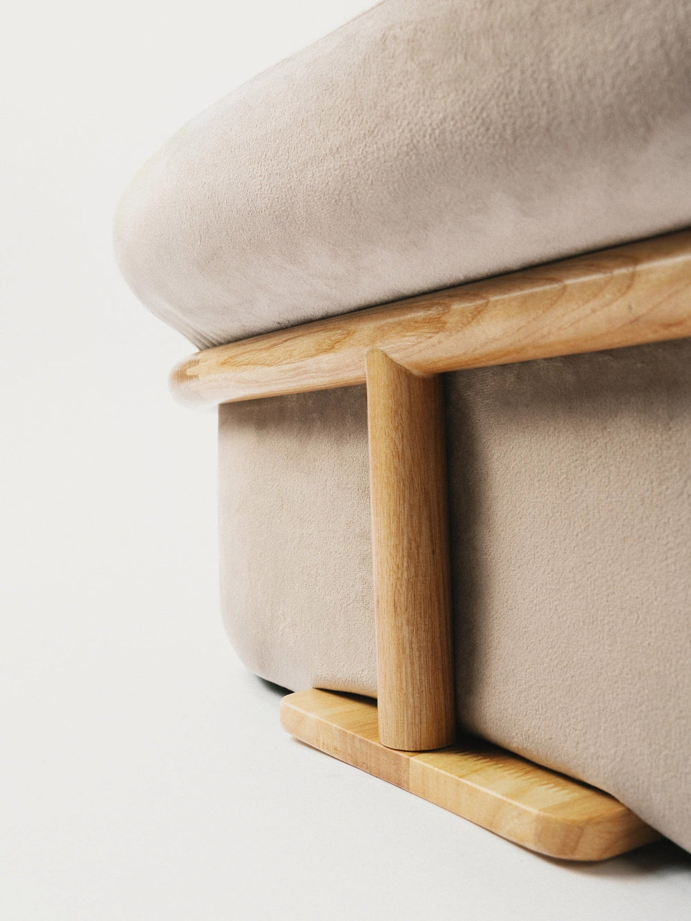 close-up-of-wooden-leg-on-side-of-kamamuta-bread-sofa-with-warm-background