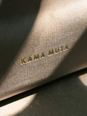 close-up-of-kamamuta-golden-logo-on-bread-sofa-under-light-and-shadow