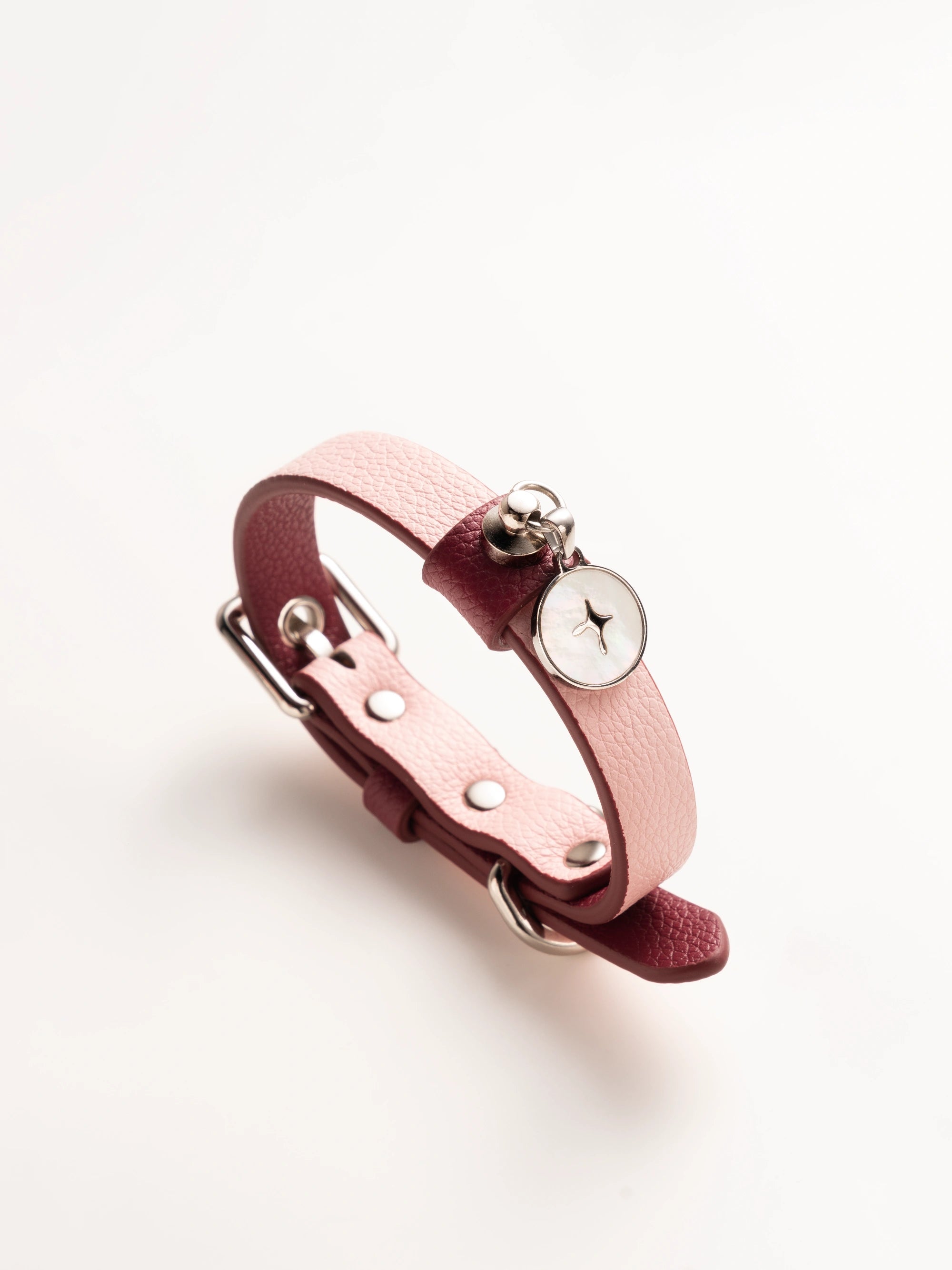 close-up-of-ulan-pink-kamamuta-dog-collar-on-white-background close-up-of-ulan-pink-kamamuta-dog-collar-on-white-background