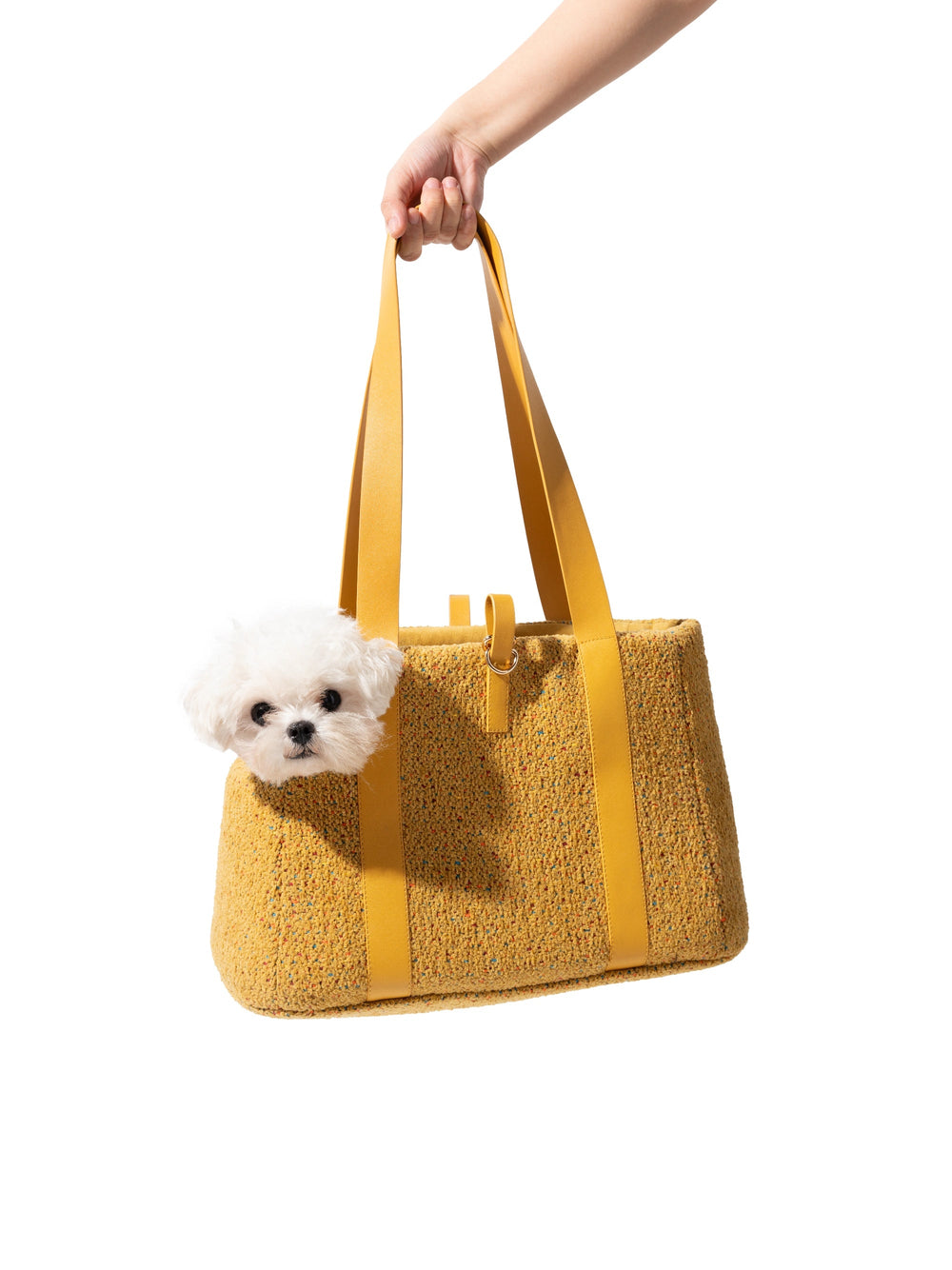 hand-holding-kamamuta-mini-tweed-pet-tote-bag-with-small-white-dog-inside-peeking-forward
