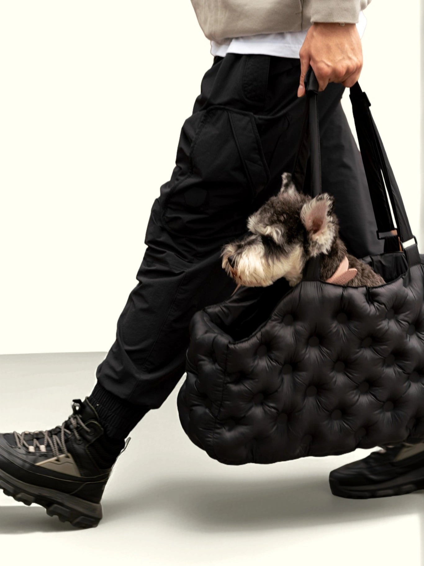 person-walking-carrying-kamamuta-black-airy-pet-bag-with-schnauzer-sitting-inside person-walking-carrying-kamamuta-black-airy-pet-bag-with-schnauzer-sitting-inside