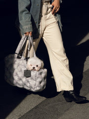 person-walking-on-road-holding-kamamuta-airy-pet-bag-with-white-dog-peeking-head-out