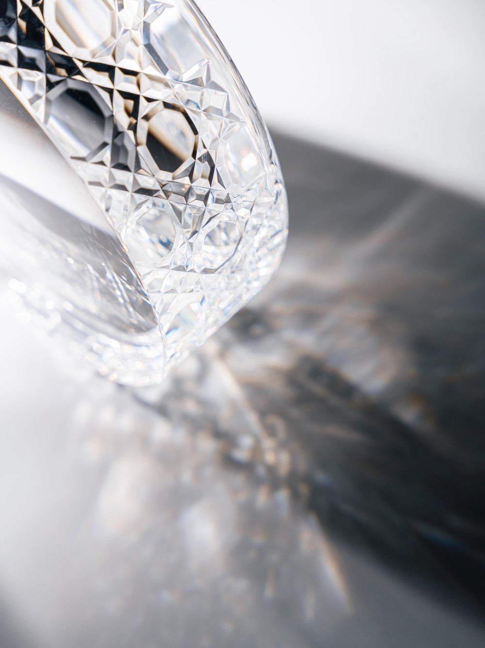 close-up-kamamuta-edo-kiriko-crystal-pet-bowl-light-refraction-on-table-surface