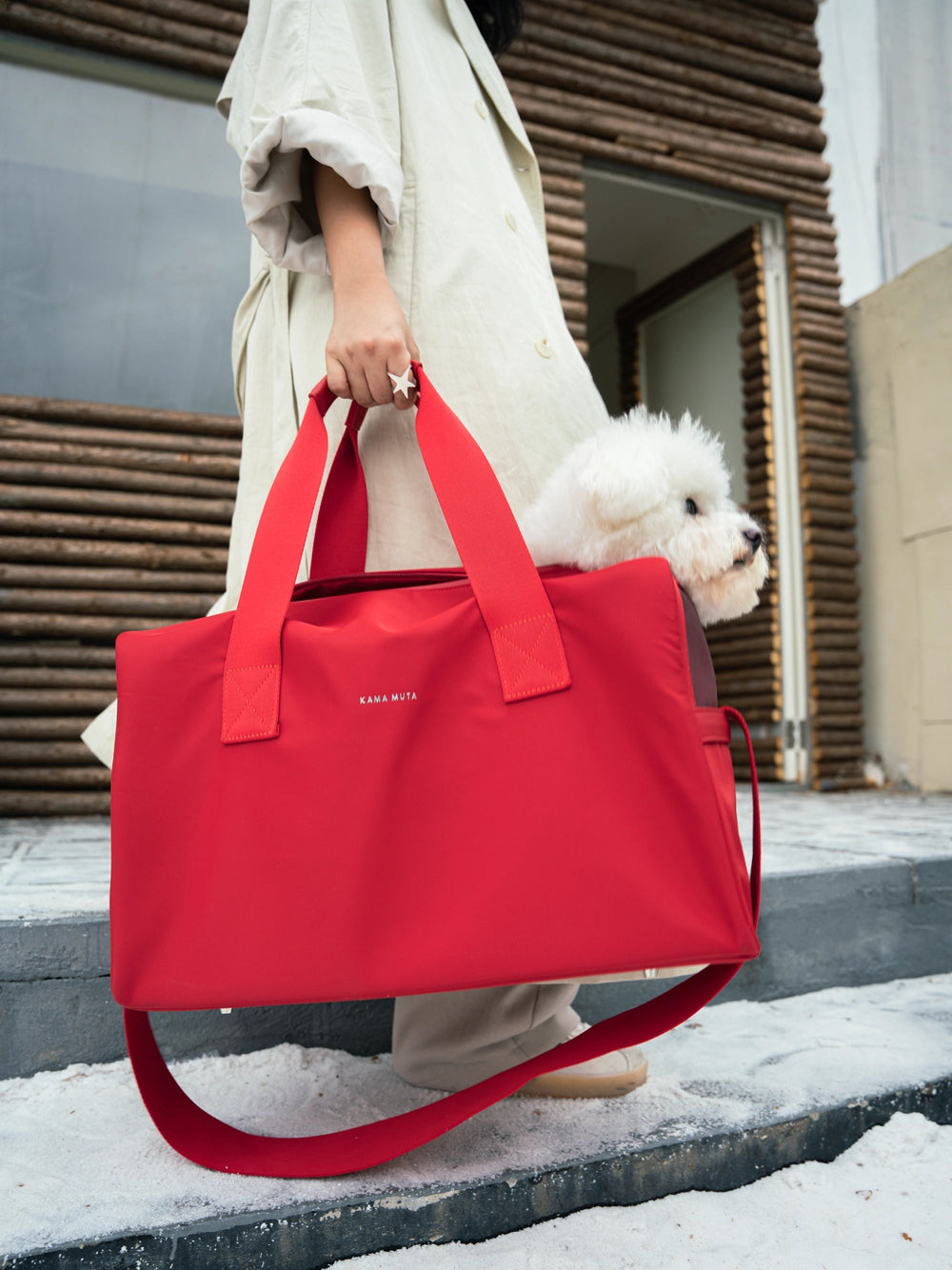 hand-holding-red-kamamuta-pet-shadow-stealth-whisper-square-bag-with-white-dog-peeking-head-out
