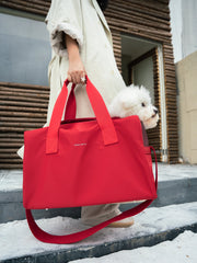 hand-holding-red-kamamuta-pet-shadow-stealth-whisper-square-bag-with-white-dog-peeking-head-out