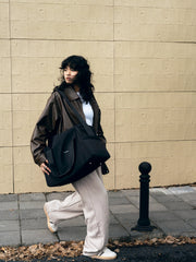 woman-walking-on-road-shoulder-carrying-kamamuta-black-pet-shadow-square-stealth-whisper-pet-carrier-bag
