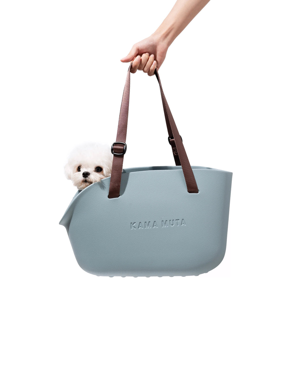 hand-holding-kamamuta-blue-pet-tote-bag-with-white-maltese-dog-inside-minimalist-white-background