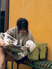 a-lady-near-white-dog-sitting-inside-yunhe-green-pet-tote-bag-on-seat