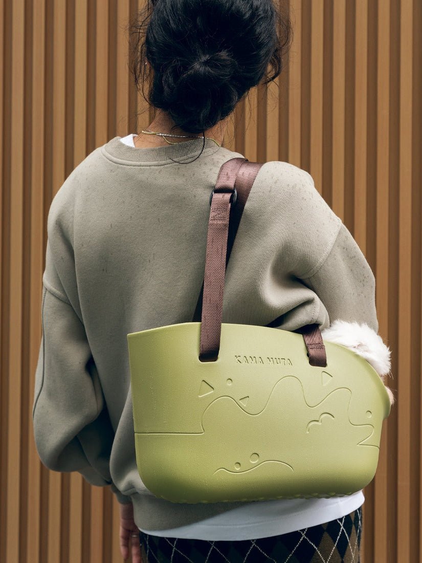 a-lady-carry-kamamuta-medog-green-mini-pet-tote-bag-with-a-white-dog-inside