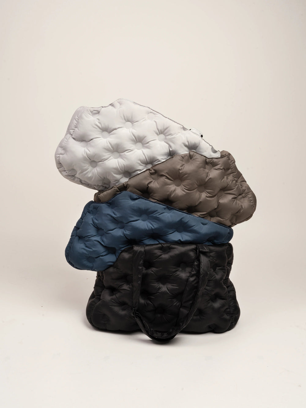 white-brown-blue-black-kamamuta-airy-pet-bags-stacked-together