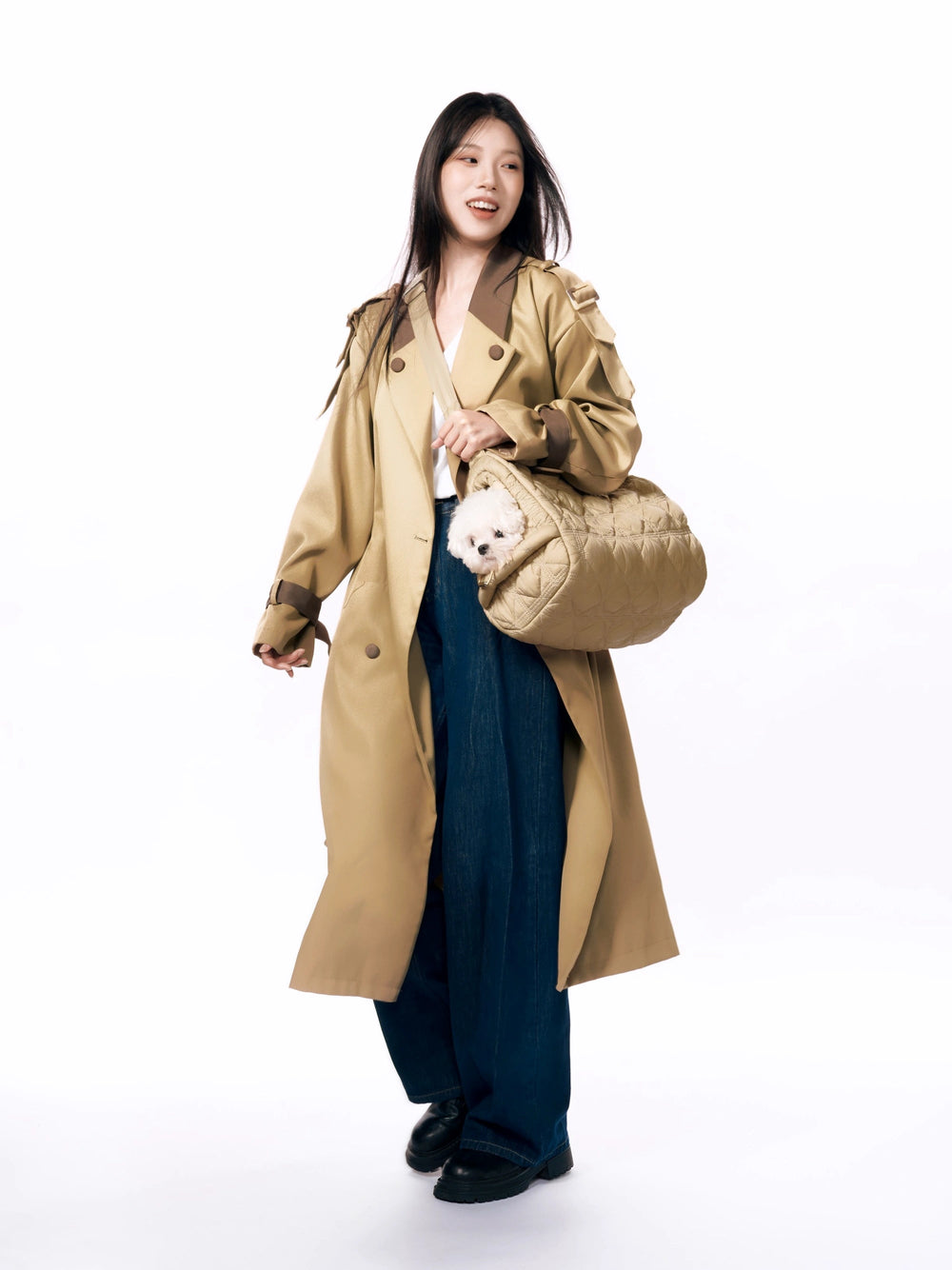 woman-in-trench-coat-wearing-kamamuta-pinecone-pet-carrier-crossbody-with-white-maltese-dog-peeking-out